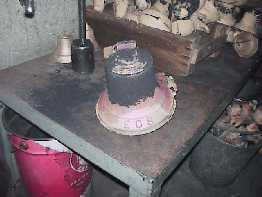 The bell ingots are removed from the dies